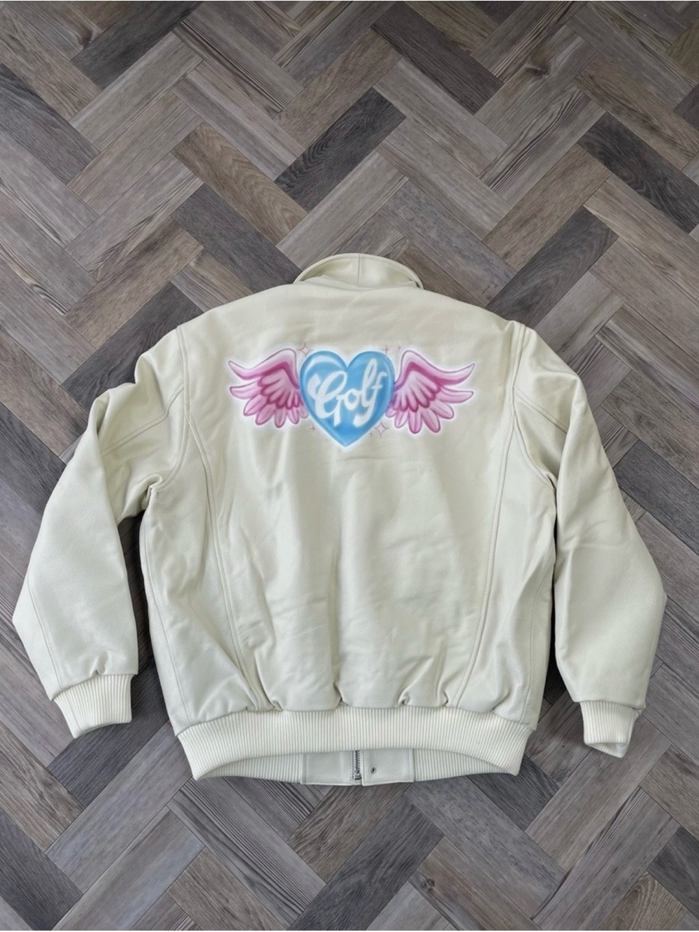 Golf Wang Cream Bomber Jacket with Pink Winged Heart and Blue Logo